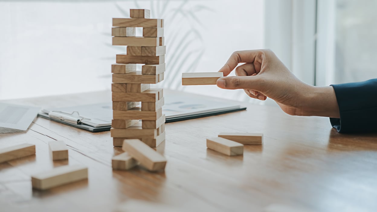 Hand Playing with a Wooden Jenga